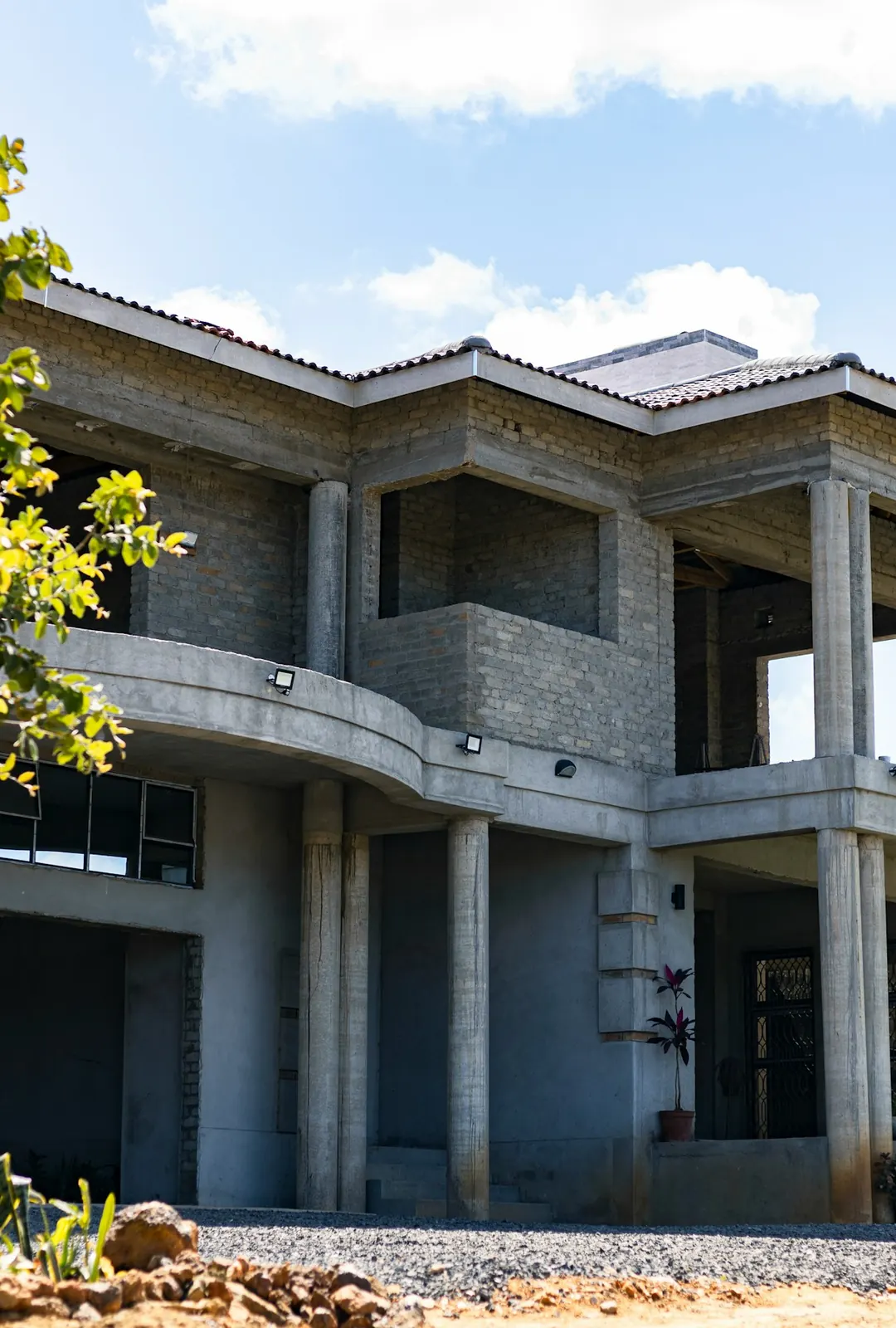 A two-story concrete block home with its tie beams poured