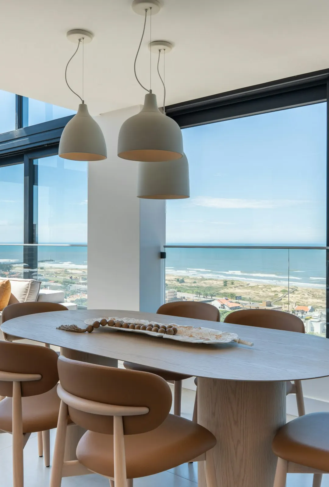 A model residence dining room with glass walls to the ocean